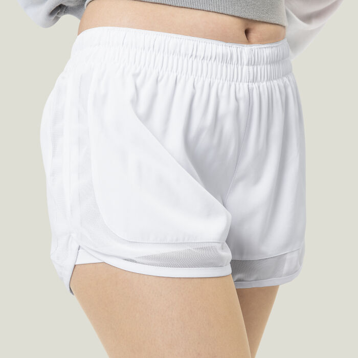 Close-up of person wearing white athletic shorts, representing casual school incidents involving dress code and student activities.