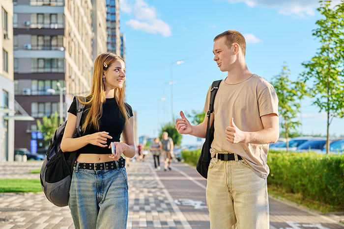 Young woman and man talking outdoors, capturing rage-baits from women with attitude to challenge men’s day.