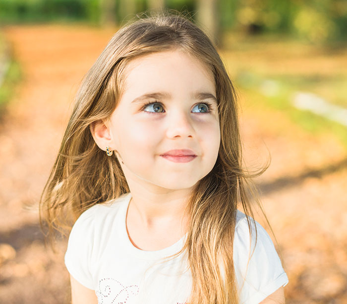 Young girl with long hair outdoors on a sunny day, illustrating stories of people who badly messed up at work.