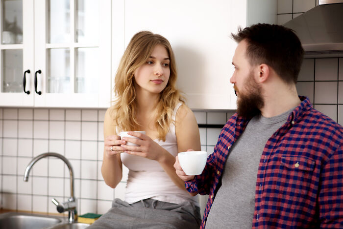 A man and woman having a candid conversation over coffee, sharing things they would never admit in real life.