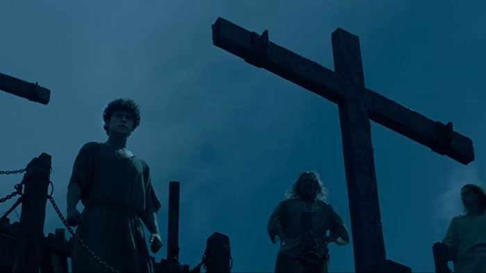 Scene from new horror film featuring Nicolas Cage as Jesus' dad, with dark crosses and characters in dramatic lighting. Scene from new horror film featuring Nicolas Cage as Jesus' dad, with dark crosses and characters in dramatic lighting.