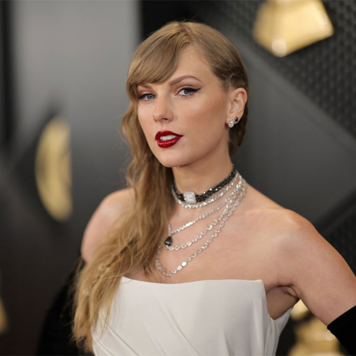 Taylor Swift with bold red lipstick and layered necklaces at a glamorous shoot, inspiring Life Of A Showgirl conspiracy theories. Taylor Swift with bold red lipstick and layered necklaces at a glamorous shoot, inspiring Life Of A Showgirl conspiracy theories.