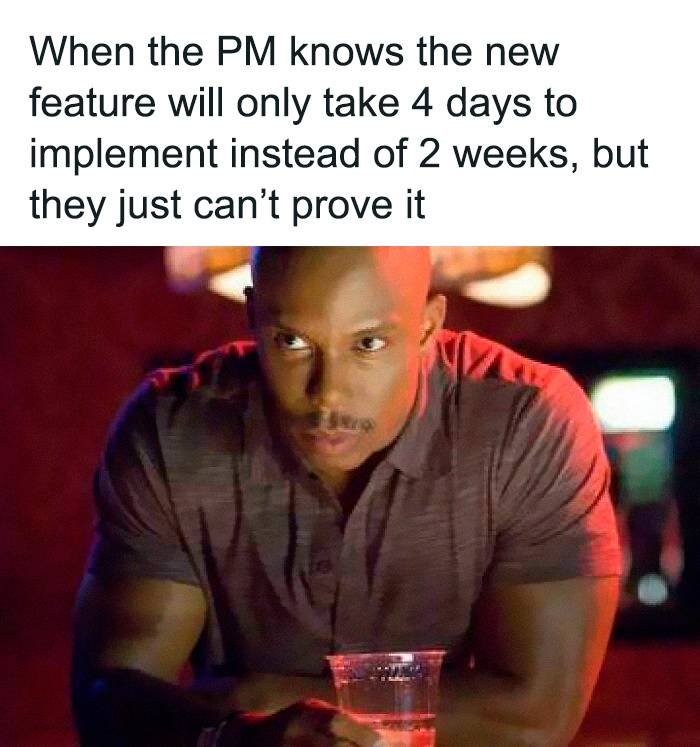 Man thinking deeply in a dimly lit bar, illustrating a programming and computer science meme about project timing and proof.