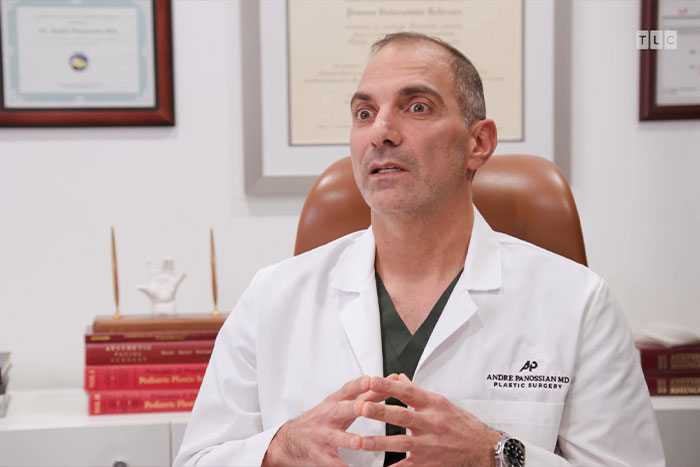 Doctor in white coat discussing urgent help for man with 4-lb face tumor in a medical office setting