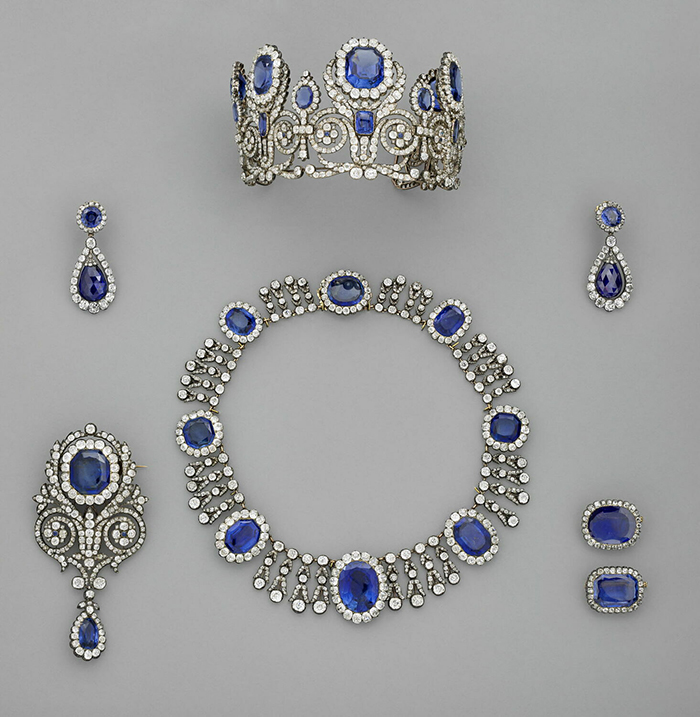 Set of vintage sapphire and diamond jewelry including a necklace, tiara, earrings, and brooch linked to jewel thief stories.