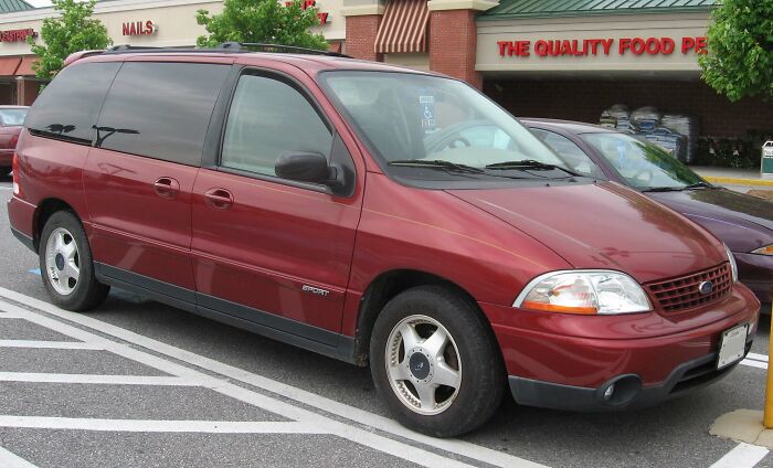 A maroon minivan parked outside a store, representing a typical setting for true crime fans discussing cases.