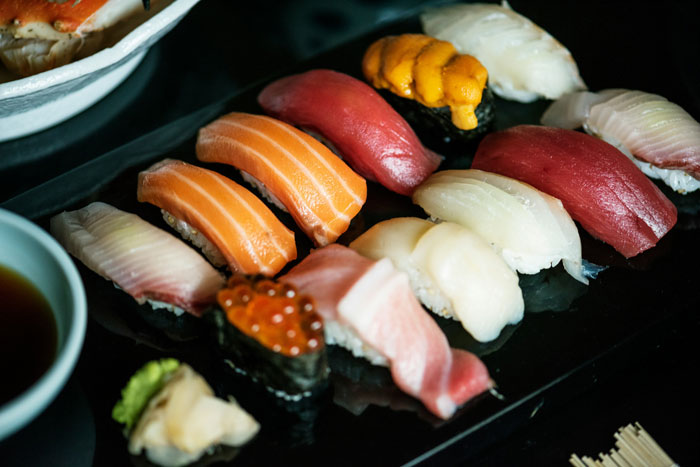Assorted sushi pieces on black platter with soy sauce and wasabi, illustrating waiter assumed 40 change was tip scenario. Assorted sushi pieces on black platter with soy sauce and wasabi, illustrating waiter assumed 40 change was tip scenario.