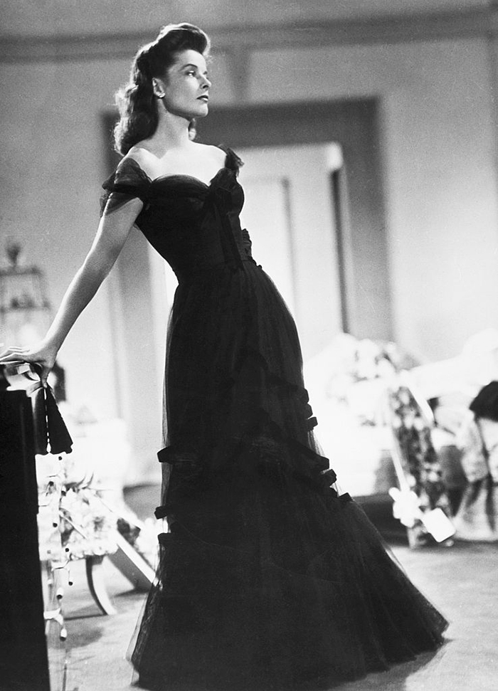 Woman in a vintage black gown representing the changing ideals of the perfect female body over 100 years