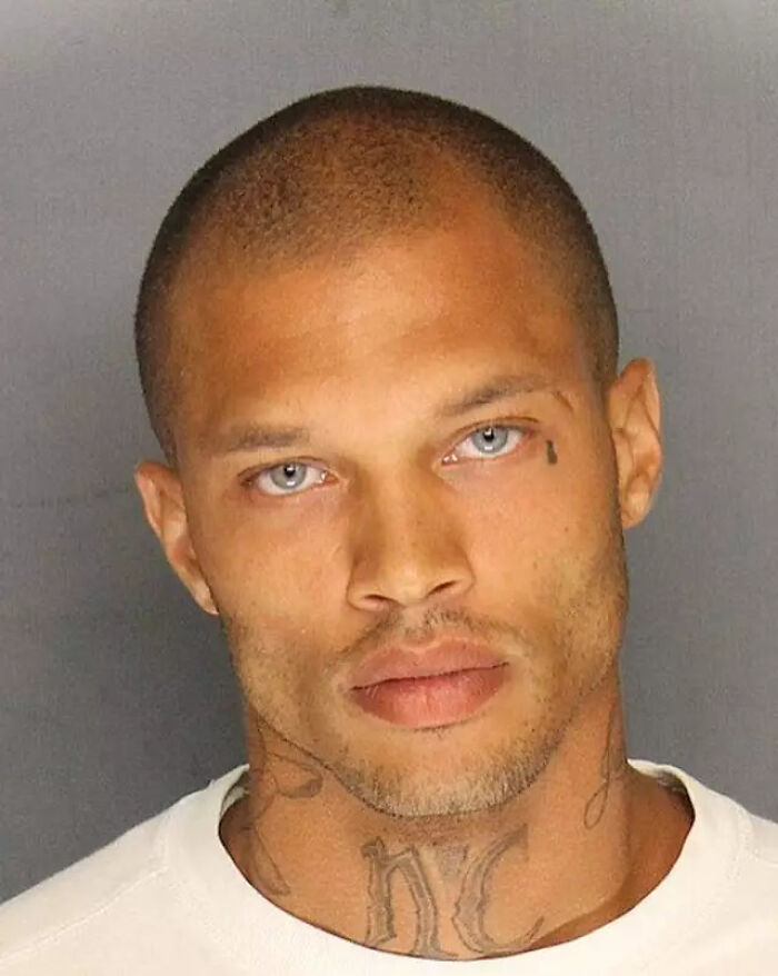 Close-up photo of the world's hottest felon showing tattoos and an intense expression at age 41.