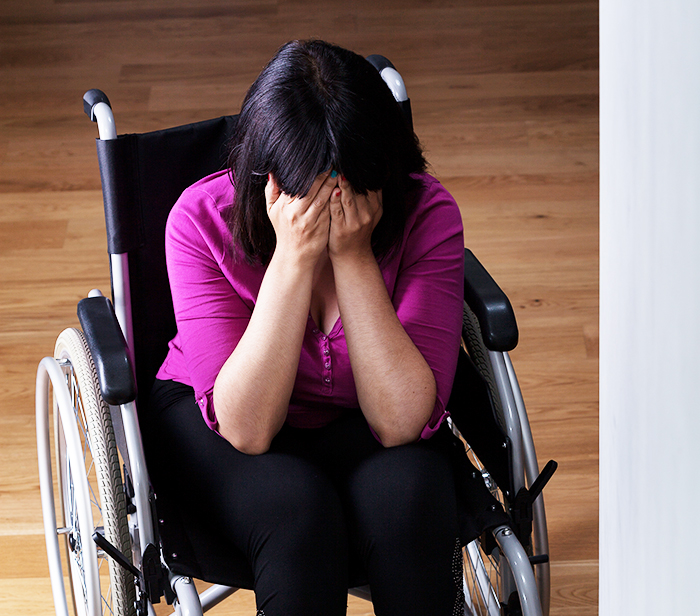 Woman in wheelchair covering her face, depicting the emotional impact of ableist accusations in family care disputes. Woman in wheelchair covering her face, depicting the emotional impact of ableist accusations in family care disputes.
