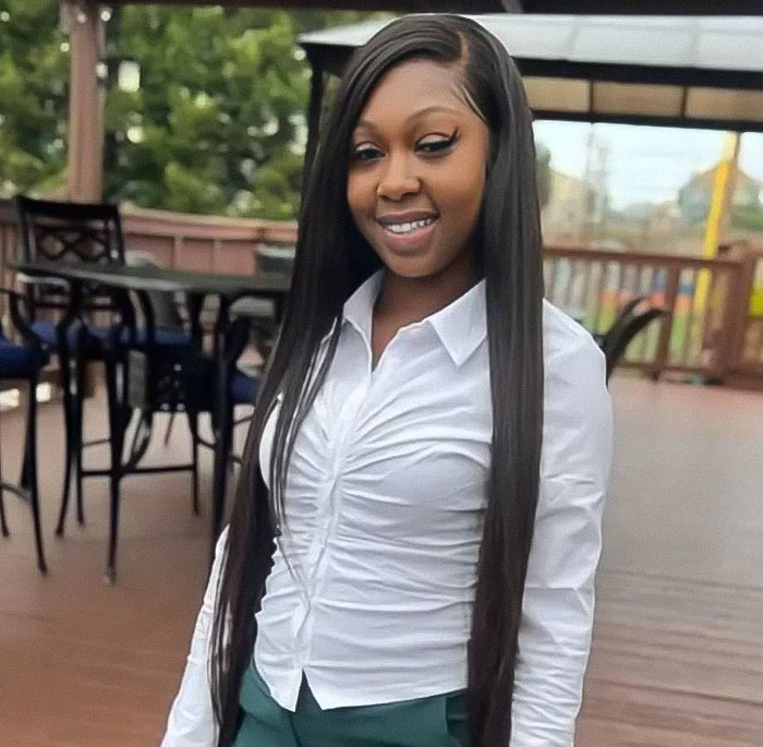 Young woman smiling outdoors on a porch, related to missing woman's body discovered behind a secret wall in hoarder's home. Young woman smiling outdoors on a porch, related to missing woman's body discovered behind a secret wall in hoarder's home.