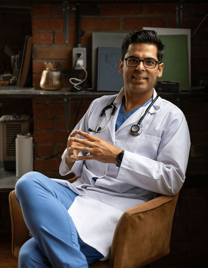 Harvard doctor in white coat and stethoscope seated in a chair discussing hidden dangers in household items. Harvard doctor in white coat and stethoscope seated in a chair discussing hidden dangers in household items.