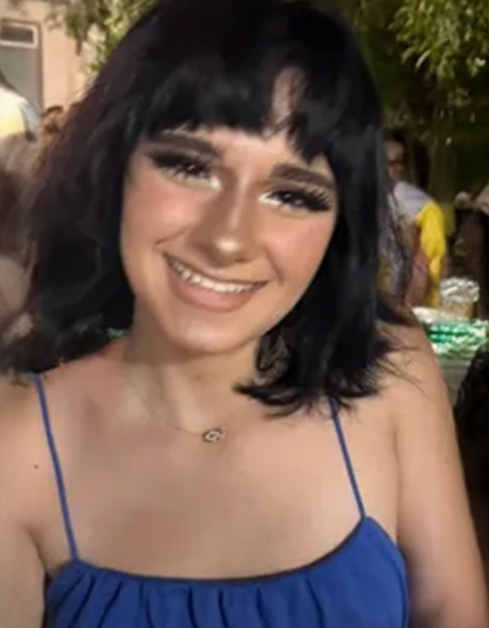 Teen driver with black hair and blue dress smiling outdoors, related to fatal hit-and-run and legal responsibility debate.