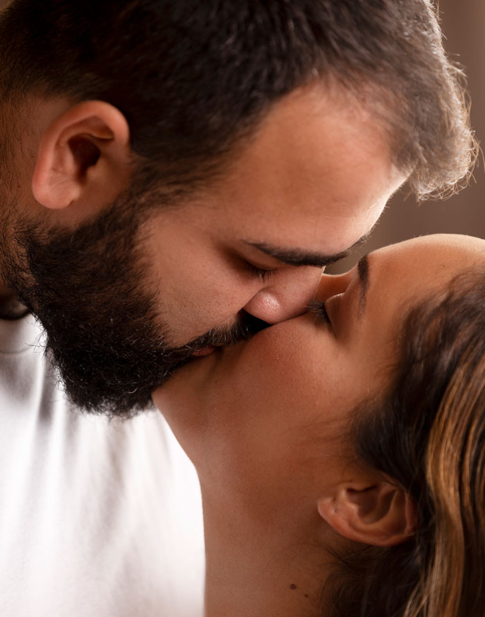Close-up of a couple sharing an intimate moment, reflecting personal family secrets daycare workers might encounter.