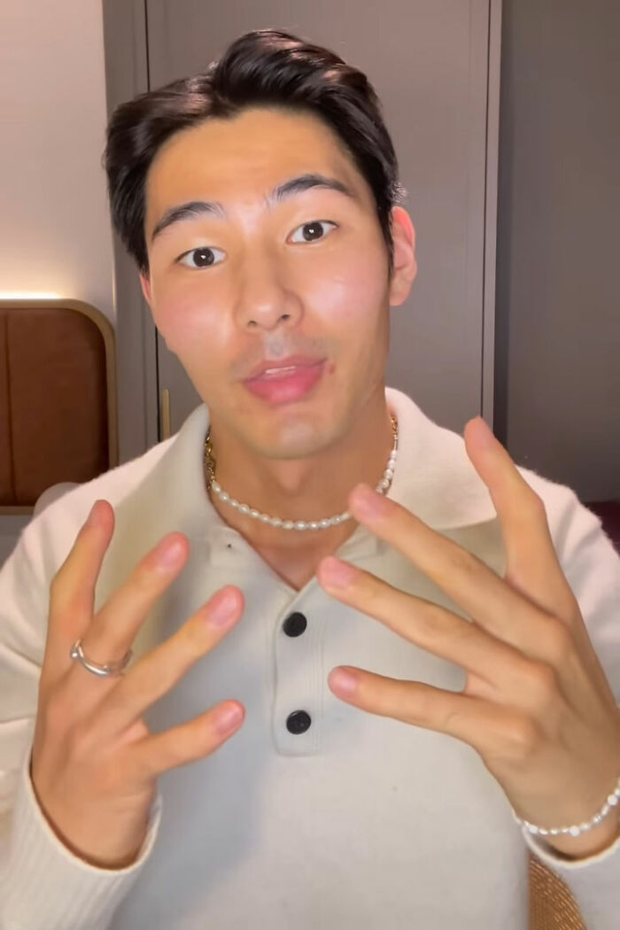 Young man demonstrating life hacks with expressive hands, showcasing thumbless creativity and quirky humor in a casual setting. Young man demonstrating life hacks with expressive hands, showcasing thumbless creativity and quirky humor in a casual setting.