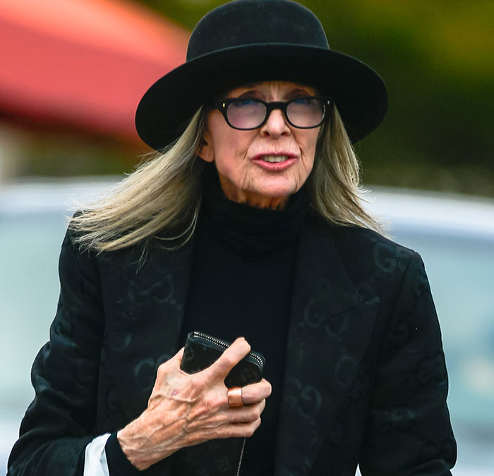 Diane Keaton wearing black hat and glasses outdoors, related to last moments revealed in 911 call and tributes.
