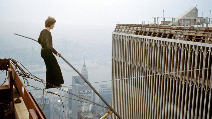 Man walking on a high wire between skyscrapers, a scene from movies based on true stories that feel impossible to believe