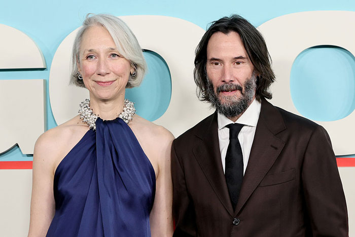 Keanu Reeves and Alexandra Grant posing together at an event amid marriage rumors and public interest.