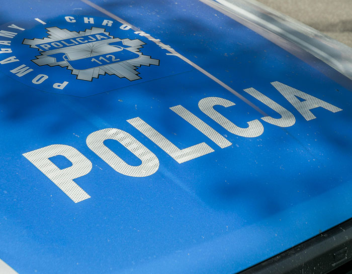 Close-up of a Polish police car hood indicating involvement in a teen missing 27 years case discovered at parents&rsquo; house.