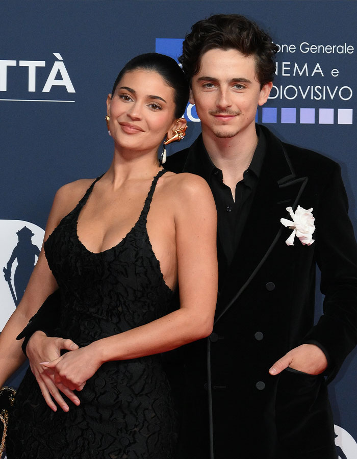 Timoth&eacute;e Chalamet and woman posing on blue carpet, dressed in black, highlighting Gwyneth Paltrow's confession influence.