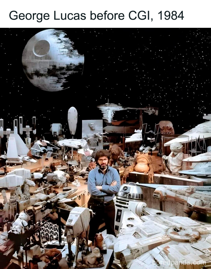 George Lucas surrounded by vintage Star Wars models and props, highlighting nostalgia for people who recognize them.