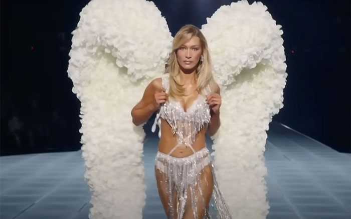 Bella Hadid walking runway wearing large Victoria&rsquo;s Secret Angel wings during a fashion show event.