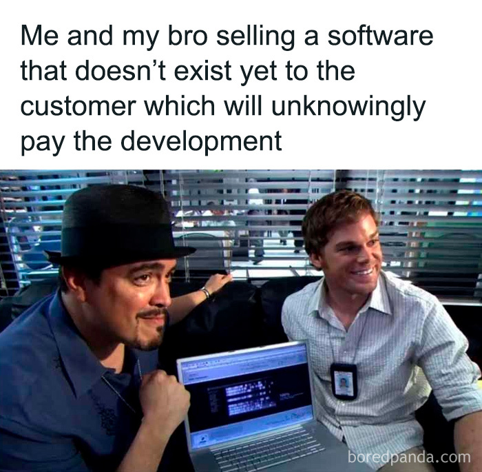 Two men smiling with a laptop showing code, representing programming and computer science meme humor.