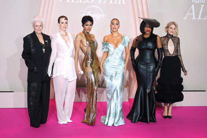 Naomi Watts and Sarah Paulson in bold braless outfits posing on the pink carpet alongside Kim Kardashian and others.