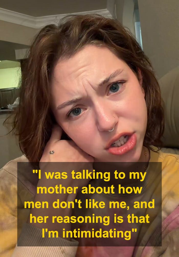 Woman with short brown hair and removed nose ring, discussing how men perceive her and political views.