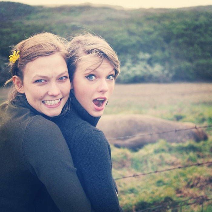 Two women outdoors, one hugging the other from behind, reflecting Taylor Swift lesbian relationship rumors with Karlie Kloss.