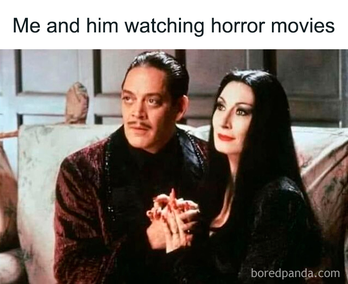 A couple watching horror movies together, capturing a relatable moment for horror and Halloween fans.