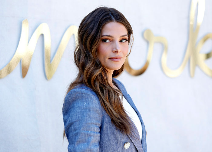 Female celebrity with long wavy hair wearing a blue blazer, illustrating the brutally expensive lifestyle of being famous.