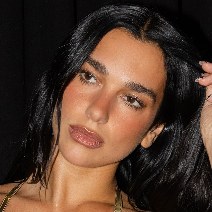Dua Lipa close-up portrait with dark hair and makeup, related to massive outrage over alleged inappropriate concert incident. Dua Lipa close-up portrait with dark hair and makeup, related to massive outrage over alleged inappropriate concert incident.