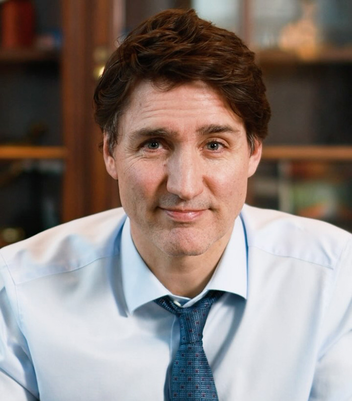 Justin Trudeau in light blue shirt and tie, sitting indoors with a calm expression, relating to Katy Perry romance expert claims. Justin Trudeau in light blue shirt and tie, sitting indoors with a calm expression, relating to Katy Perry romance expert claims.