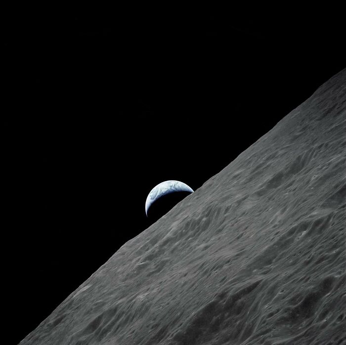 View of Earth rising over the moon's horizon, showcasing epic astronomy and the beauty of space mysteries.