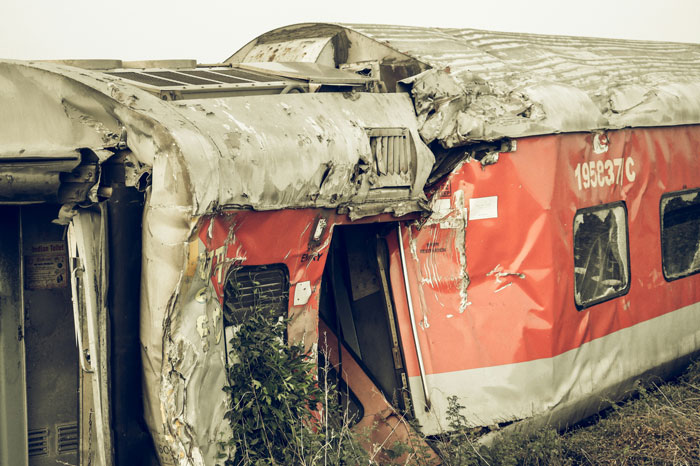 Derailment of a badly damaged train car in a wild scene evoking urgent we need to leave right now stories.