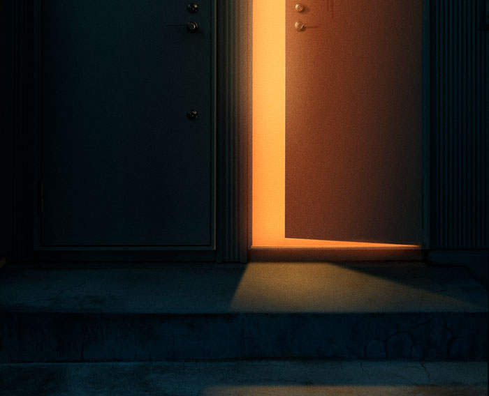 Partially open door with warm light shining through, symbolizing unexpected and awkward moments people saw.