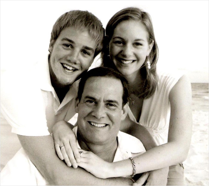 Mom of late Taylor Swift friend smiling with two young adults in a warm, affectionate family portrait.