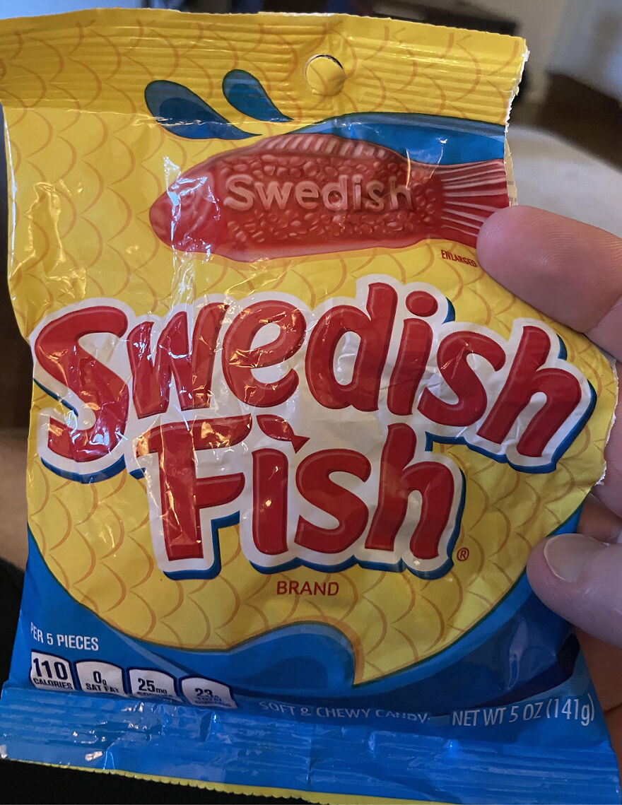 Swedish Fish candy package held in hand, a popular Halloween candy ranked by readers in 2025.