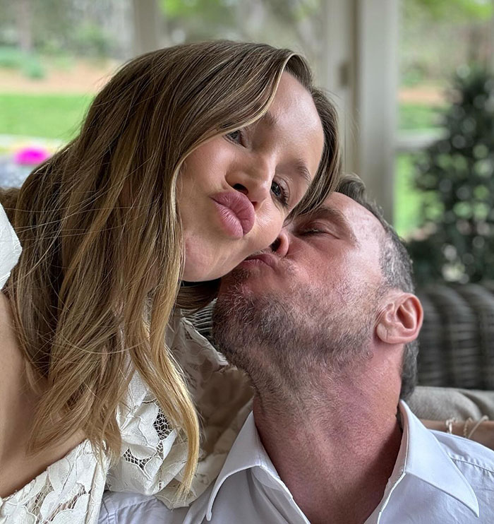 Kristen Bell and partner sharing a close moment outdoors, amid experts condemning her triggering post and behavior backlash.