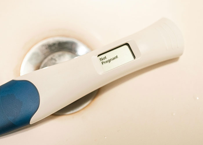 Digital pregnancy test showing not pregnant result, relating to creepy things women said or did to men.
