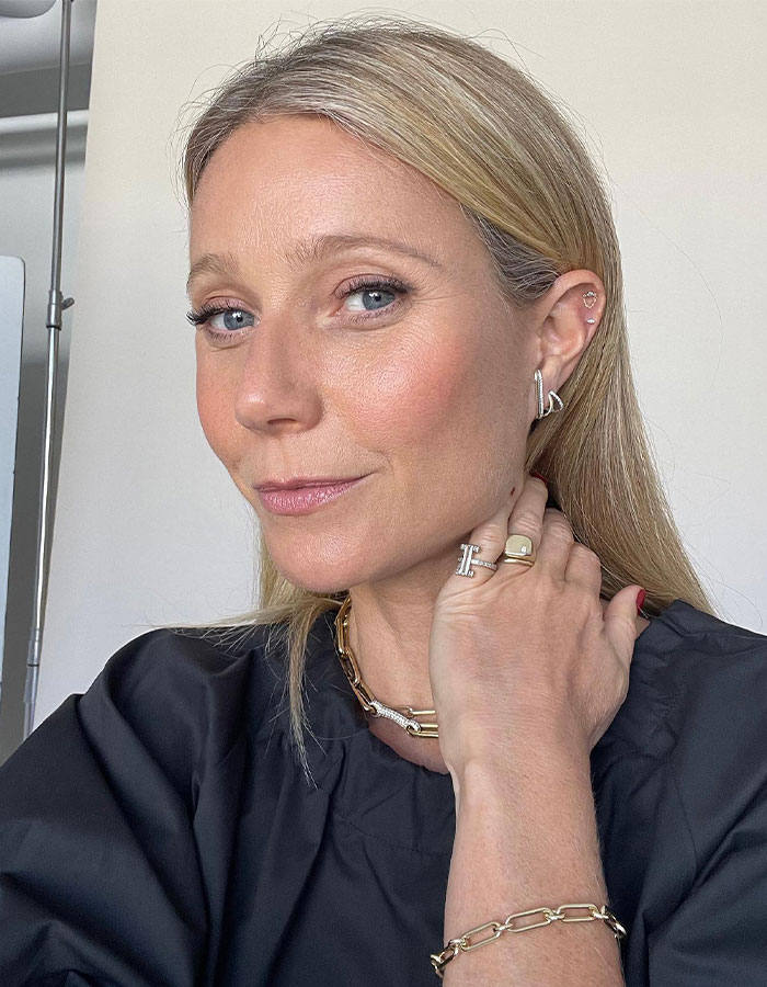 Close-up of a female celebrity with blonde hair and jewelry, illustrating tone-deaf celebs mocking people earning less.