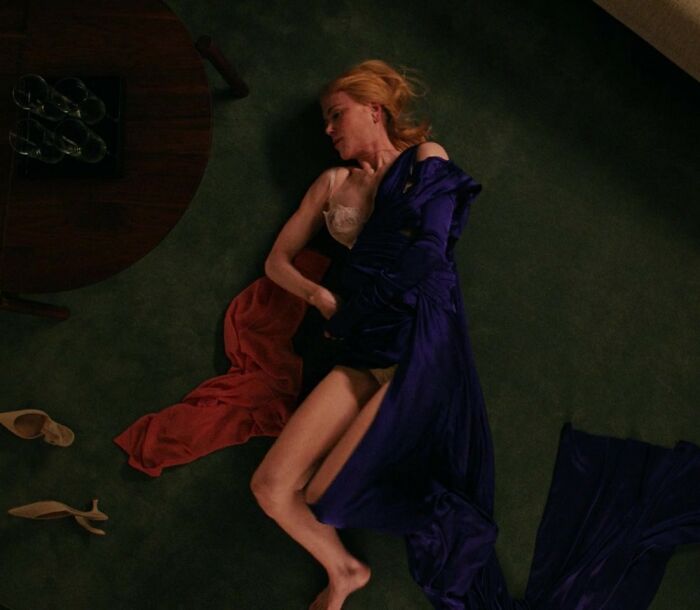 Nicole Kidman lying on the floor in a purple dress, conveying intimacy amid Keith Urban divorce discussion.