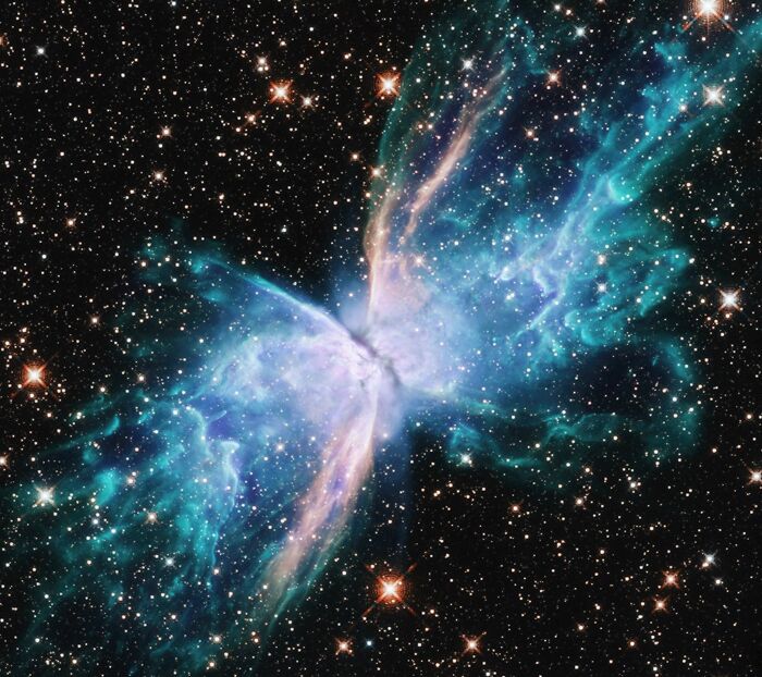 Vibrant astronomy photo of a colorful butterfly-shaped nebula showcasing the beauty and mystery of space.
