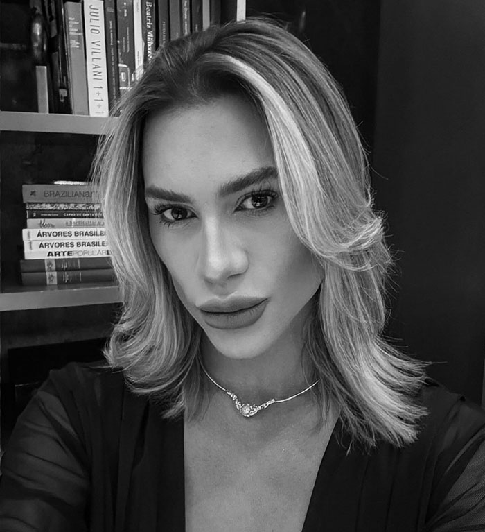 Black and white portrait of a woman with styled hair, highlighting complications from popular fox eyes surgery risks.