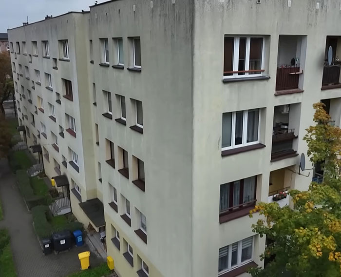 Exterior view of a multi-story residential building where a teen missing for 27 years was discovered living in horrific condition.