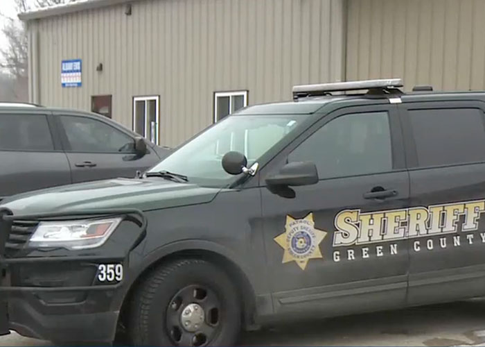 Green County sheriff vehicle parked outside a building related to a 16YO dad and newborn baby incident.