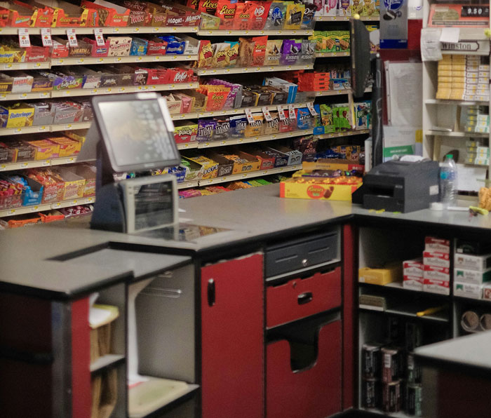 Convenience store counter with candy shelves behind, illustrating local scenes related to worst crimes in hometowns.
