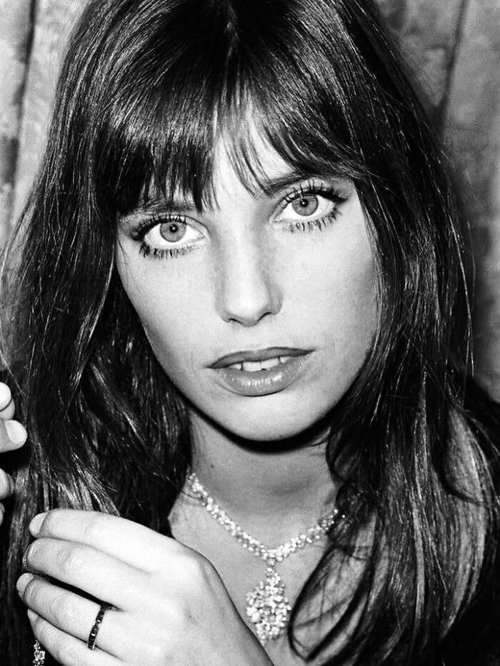 Black and white portrait of a woman with long hair, highlighting influential people in the movie and music industries.