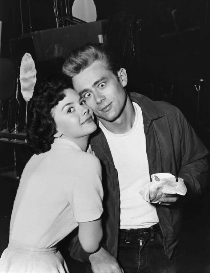 Black and white photo of two iconic figures who left a mark in the movie and music industries, smiling closely together.